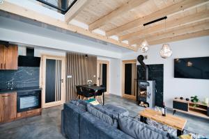 a living room with a couch and a piano at Panorama Hills by Housine in Jaszczurowa