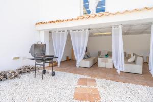 a living room with a tv and a couch and a table at RostoIl Espai de Calma in Muro