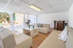a living room with white furniture and a large window at RostoIl Espai de Calma in Muro
