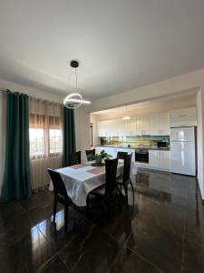a kitchen and dining room with a table and chairs at Natalie’s House in Alexandroupoli