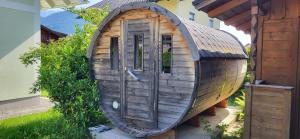 a small wooden boat sitting next to a building at Ferienhaus Aich by Alpenidyll Apartments in Gössenberg
