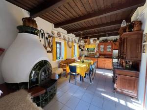a kitchen with a table and a stove in a room at The Nádas House in Abádszalók