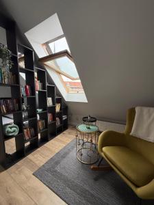 a living room with a skylight and a couch and a table at Old Town Apartment in Riga