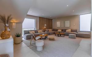 a living room with a couch and a table at Brand New Design Villa with Heated Pool and Sea view in Pomer +55 photos