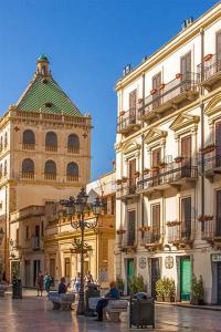 a group of buildings and a building with a tower at Perla delle Egadi in Marsala