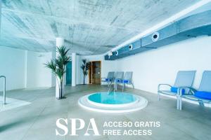 a room with chairs and a fountain in the middle at Spirit Hotel Benalmadena Beach in Benalmádena