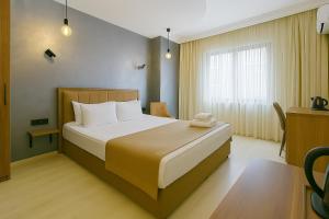 A bed or beds in a room at Monezza Avcılar