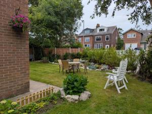 a yard with chairs and a table in the grass at Highcross Corner in Poulton le Fylde