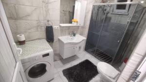 a bathroom with a shower and a toilet and a sink at Engin HOME in Pamukkale