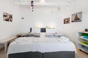 a bedroom with a large white bed in a room at Hotel Selini in Agios Nikitas