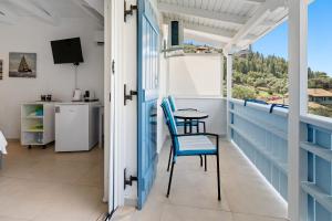 a balcony with a table and chairs and a view at Hotel Selini in Agios Nikitas