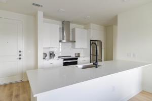 a white kitchen with a large white counter top at Blueground Round Rock pool nr Chisholm Trail ATX-325 in Austin