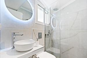 a bathroom with a white sink and a shower at Hotel Selini in Agios Nikitas