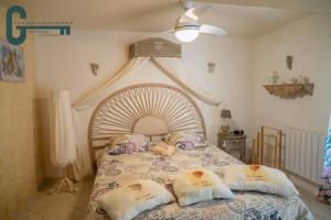 a bedroom with a large bed with pillows on it at Séjour détente avec spa, piscine et sauna in Mas-Saintes-Puelles +21 photos