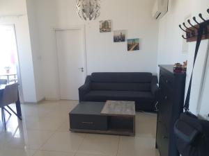 a living room with a couch and a table at Fantastic sea views in Larnaka