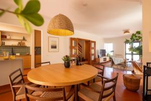 a dining room and living room with a table and chairs at Wave Song Villa in Santo Isidoro