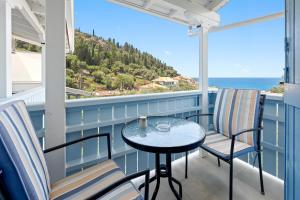 a balcony with a table and chairs and the ocean at Hotel Selini in Agios Nikitas