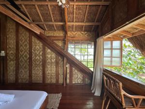a bedroom with a bed and a large window at LAWI Haven Homestay with Dorm in Burgos