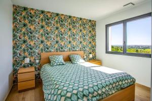 a bedroom with a bed with a floral wallpaper at Villa Zephyr by Villa Plus in Tourbes +15 photos