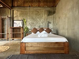 a bedroom with a bed with white sheets and pillows at LAWI Haven Homestay with Dorm in Burgos