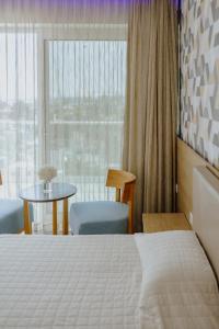 Кровать или кровати в номере Seasons Hotel (Adults Only)