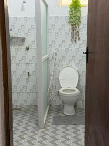 a bathroom with a toilet and a shower at Aligna Bamburi in Mombasa