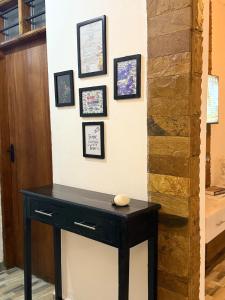 a black table in a room with pictures on the wall at Aligna Bamburi in Mombasa
