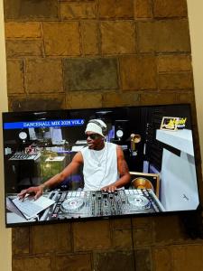 a man standing behind a mixing console in a kitchen at Aligna Bamburi in Mombasa