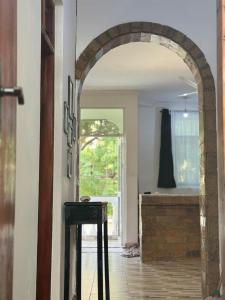 an archway leading into a bathroom with a tub at Aligna Bamburi in Mombasa