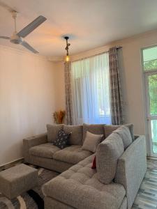a living room with a couch and a window at Aligna Bamburi in Mombasa