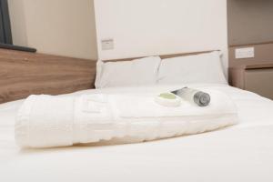 a white bed with a camera on top of it at Ensuite Single Room in Central Coventry in Coventry +14 photos