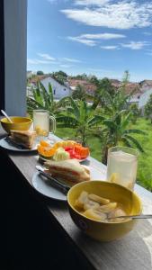 a table with a plate of food and a bowl of food at Banana Homestay in Banyuwangi