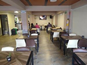 a restaurant with tables and chairs and people sitting at tables at Hotel Iraca in Aquitania