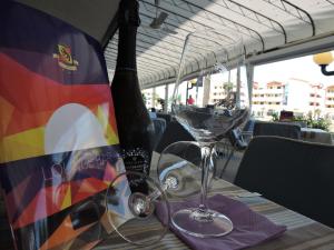 a bottle of wine and a glass on a table at Hotel Berna in Eraclea Mare