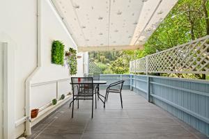 a patio with chairs and a table on a blue deck at Hotel Selini in Agios Nikitas