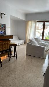 a large bedroom with two beds and a piano at C&M in Mar del Plata