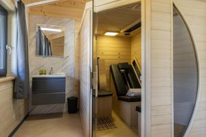 a small bathroom with a sink and a mirror at Clofers Nature Chalets Obermöschach in Hermagor +97 photos