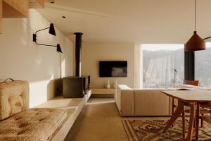 a living room with a couch and a fireplace at Dajas Douro Valley - Exclusive Villas in Sande