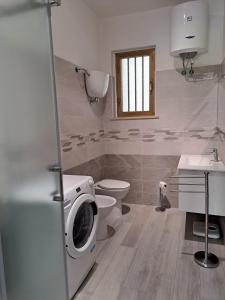 a bathroom with a washing machine and a toilet at Torre Galli-Dimora di Campagna in Gasponi +106 photos