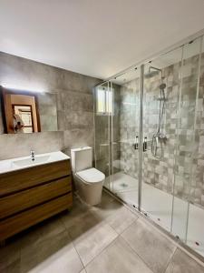 a bathroom with a shower and a toilet and a sink at Bungalow Benicasim REF 034 in Benicàssim