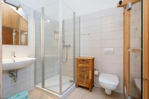 a bathroom with a shower and a toilet and a sink at Strandpark Sierksdorf H051 in Sierksdorf +19 photos