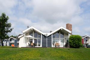 a house with a lot of windows on a yard at Strandpark Sierksdorf H051 in Sierksdorf