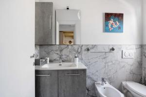 a bathroom with a sink and a toilet and a mirror at Casa Mary Vicino a Camaiore in Camaiore