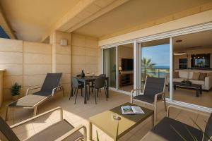 a living room with a table and chairs at Magnificent 3BR-2BA in Marina Herzliya w Pool in Herzliyya B