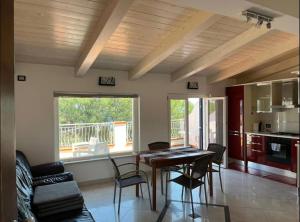 a kitchen and dining room with a table and chairs at b&b montauro in Montepaone Lido