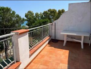 a balcony with a table and a bench on it at b&b montauro in Montepaone Lido