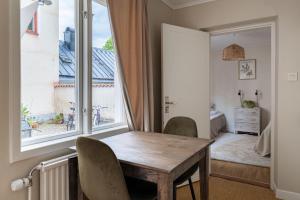a dining room with a table and a large window at Cozy studio in separate building in Visby +13 photos