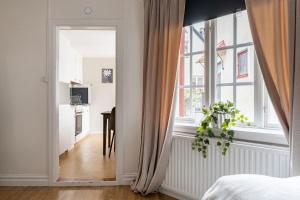 a bedroom with a door leading to a kitchen at Cozy studio in separate building in Visby