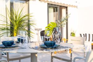 a white table with plates and glasses on a patio at Urban Rooftop Apartment in Dubrovnik