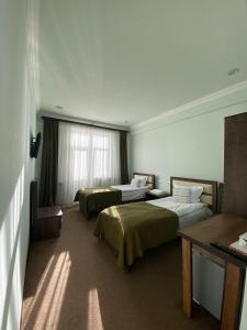 Postel nebo postele na pokoji v ubytování Mina Hotel